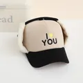 Detail of children's winter trapper hat with corduroy texture and plush earflaps - Kids / Cream and Black