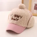 Detail of winter plush earflap hat for kids featuring SUNNY DAY embroidery and pompom - Kids (48-54CM) / Pink