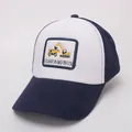 Detail view of cotton baseball cap with embroidered yellow excavator and truck patch - Navy Blue