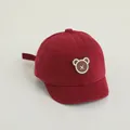 Cute dark red baby baseball cap featuring a round cartoon bear patch with X detail - Adjustable Infant Size / Wine Red with Embroidered Bear