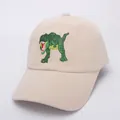 Close-up of a khaki kids baseball cap featuring a detailed green dinosaur embroidery - Style 1 / Beige