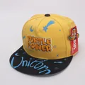 Detail of Turtle Power 3D embroidery and universe themed graphics on flat brim cap - Children 48-54cm / Yellow