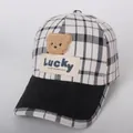 Detail of checkered kid's baseball cap featuring a plush bear patch and Lucky embroidery - 48-53cm / Black