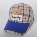 Detail of children's baseball cap with teddy bear patch and lucky woven label text - 48-53cm / Sapphire Blue