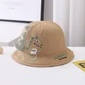 Detail of khaki kids bucket hat with 3D dinosaur fin and embroidered cartoon dinosaur - Kids Size / Coffee