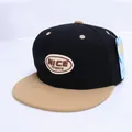 Detail view of the NICE embroidered patch on a contrast color flat brim baseball cap - Children's Size (Adjustable) / Black