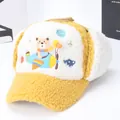 Yellow and beige winter trapper hat for kids featuring fleece lining and cartoon bear design - Yellow
