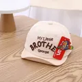 Beige baby baseball cap with My Little Brother George embroidery on wood background - Infant 0-30 Months / Beige