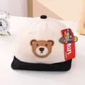 Close-up of baby mesh baseball cap with woven bear patch and breathable back design - Infant Size / Black Brim