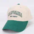 Close-up of embroidered California letters on a beige and green cotton baseball cap - Kids 3-10 Years (50-54cm) / CALIF Green Brim