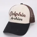 Detail of tricolor kids trucker hat featuring Dolphin Archive embroidery and mesh panels - Kids / Beige