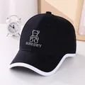 Close-up of black children's sun hat featuring white bear embroidery and contrast brim - 50-54cm / Black