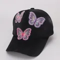 Close-up of embroidered butterfly patches with 3D organza wings on black baseball cap - Fabric Cap / Black Cloth Hat