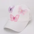 Detailed close-up of 3D embroidered butterfly patches on a white summer mesh baseball cap - White Fabric