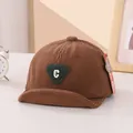 Detail of baby brown corduroy baseball cap with green C letter patch and soft brim - 45-48cm / Dark Coffee