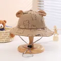Detail of khaki corduroy baby bucket hat with bear ears and adjustable chin strap - Khaki