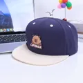 Kids navy and beige capybara baseball cap with metal sprout accent on a white desk - Kids / Navy Blue