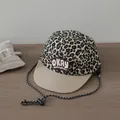 Detail of leopard print five-panel cap with flat brim and adjustable chin cord strap - OKAY Embroidery Style / Beige Brim