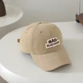 Minimalistische khakifarbene Kinder Baseballkappe mit BAD BUSINESS Stickerei auf Baumwolle - 50-54cm / Beige