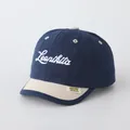 Kids navy and beige contrast baseball cap featuring white Leonikita script embroidery - 48-52cm / Navy Patchwork Beige (LEAN)