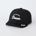 Close-up of black cotton baby baseball cap with white LOS ANGELES embroidery detail - Infant Fit / Black