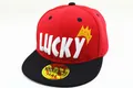 Detailopname van rode snapback pet met wit LUCKY borduurwerk en een gele kroonopdruk - Baby (2-8 Jaar) / Rood