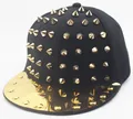Detail of hip-hop baseball cap featuring gold cone studs and a shiny metallic gold brim - Adult Gold Studs