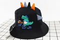 Detail of kids black bucket hat with 3D dinosaur spikes and cartoon bicycle graphics - Kids (2-6 Years) / Black