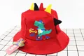 Detail of red kids bucket hat with dinosaur spines and cartoon dino print design - Kids (2-6 Years) / Red