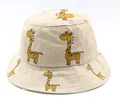 Detailed close-up of light beige cotton sun hat featuring cute yellow giraffe patterns - Kids (2-7 Years) / Beige