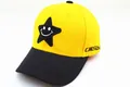 Close-up of yellow baseball cap with black star patch, smiley embroidery and side text - Kids (2-8 Years) / Star Smile Yellow