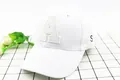 Detail of white cotton baseball cap featuring beige letter A applique and S embroidery - Kids (2-8 Years) / White