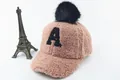 Detailed shot of pink faux shearling baby cap with black pompom and letter A embroidery - Children (3-8 Years Old) / A Marker Pink