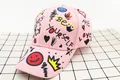 Detail of pink cotton baseball cap with colorful street graffiti and crown prints - Kids (3-12 Years) / Pink Smile Face