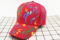 Detail of red graffiti baseball cap with Peace Love Hope print and twill cotton texture - Kids (3-12 Years) / Letter Red