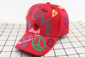 Close-up of red cotton baseball cap with LOVE print and colorful street style graffiti - LOVE Heart Style / Red