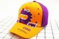 Detail of kids baseball cap featuring 3D dinosaur embroidery and Find Dinosaurs text - Children (2-8 Years Old) / Orange Purple Patchwork