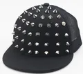 Detail of black snapback trucker hat featuring silver metal cone rivets and mesh back - Adult / Silver Rivet