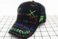 Close-up of black kids baseball cap with vibrant colorful graffiti print and curved brim - Kids / Double Cross Black