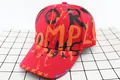 Detail of red kids baseball cap featuring graffiti style lettering and cotton twill fabric - Kids / MPL Red