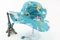 Detail of green kids sun hat with cartoon prints and adjustable white chin strap - Turquoise Cartoon Fauna/Flora Style (Fig 7)