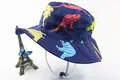 Detail of kids sun hat featuring colorful cartoon dinosaur prints and adjustable chin strap - Dark Blue Colored Dinosaur Style (Fig 10)