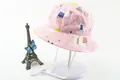 Detail of pink cotton sun hat featuring cartoon llama patterns and adjustable chin strap - Pink Alpaca Cactus Style (Fig 12)