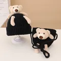 Close-up of black knitted baby hat and mini bag set with cute 3D plush teddy bear detail - Hat and Bag Set / Black