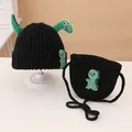 Detail of black knitted beanie and crossbody bag with 3D green dinosaur character - Knitted Hat And Crossbody Bag Set / Black