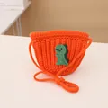 Detail of orange knitted kids purse with a green dinosaur patch and woven strap texture - Knitted Crossbody Bag / Orange