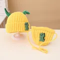Detail of yellow knit hat and matching crossbody bag with cute green dinosaur design - Knitted Hat And Crossbody Bag Set / Yellow