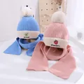 Detail of kids knit hat and scarf set featuring strawberry embroidery and soft pom poms - Kids approx 3-10 years / Pink