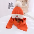 Detail of orange knitted hat and scarf set with strawberry embroidery and soft fur pompom - Kids approx 3-10 years / Orange