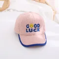 Close-up of pink lamb wool kids baseball cap featuring blue Good Luck embroidery - Kids / Pink